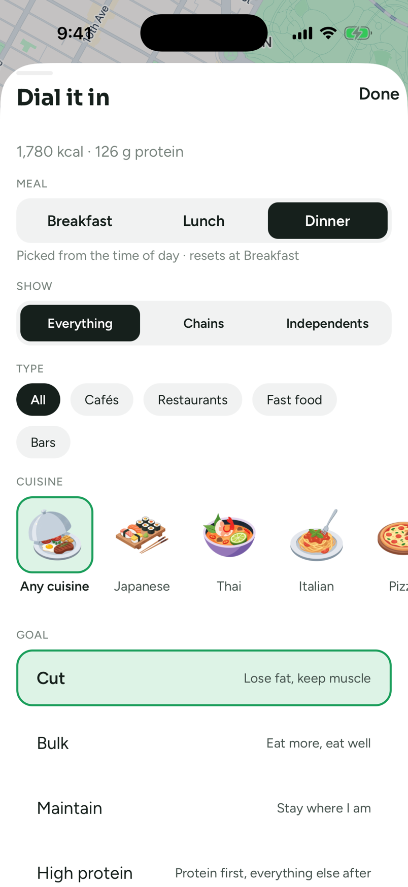 The Dial it in sheet: a Meal segment with Dinner selected, a Show segment on Everything, Type chips for All, Cafés, Restaurants, Fast food and Bars, a row of cuisine tiles — Any cuisine selected in green, then Japanese, Thai, Italian and Pizza — and a Goal list with Cut selected, captioned Lose fat, keep muscle, above Bulk, Maintain and High protein.